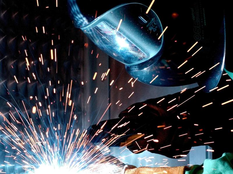person welding with face shield on