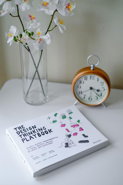 The Design Thinking Playbook book on coffee table